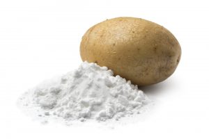 Heap of potato starch and a fresh potato isolated on white background